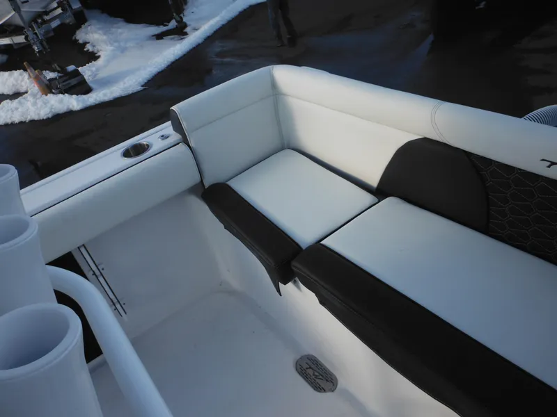Slide: The Image of 2025 Tidewater 232 LXF boat interior with cushioned seating and cup holders. - 32