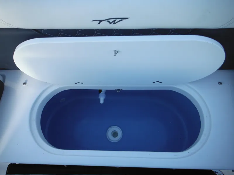 Slide: The Image of 2025 Tidewater 232 LXF boat livewell with open lid, showcasing interior design. - 35