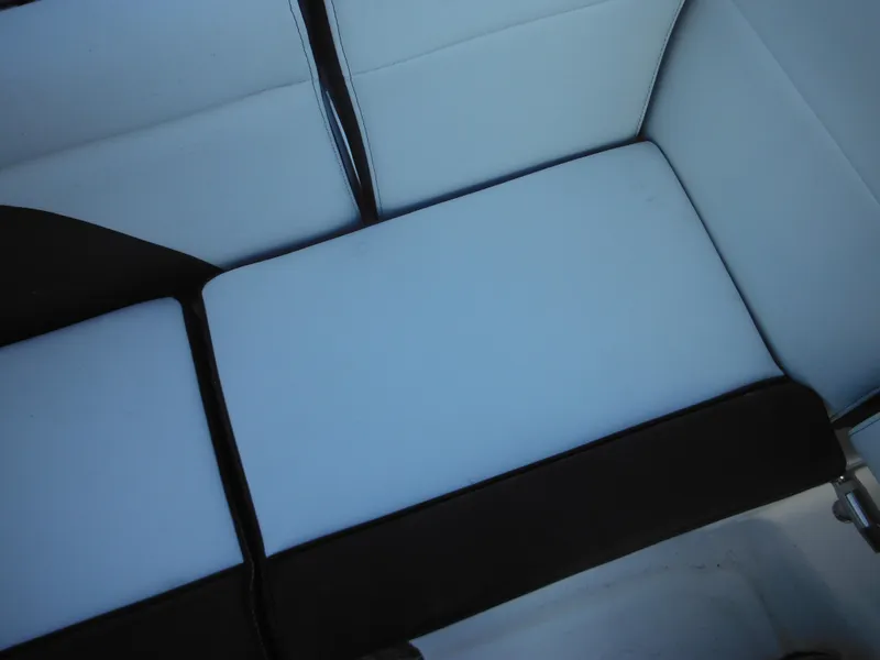 Slide: The Image of 2025 Tidewater 232 LXF boat seating, featuring sleek white and black upholstery. - 36