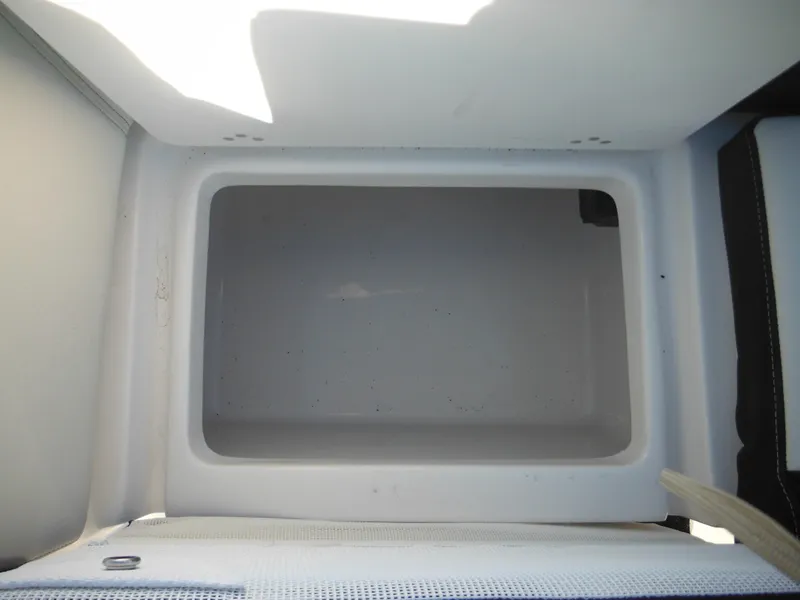 Slide: The Image of Empty storage compartment in a 2025 Tidewater 232 LXF boat. - 39