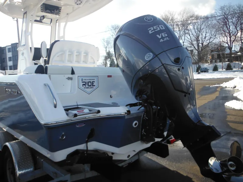 Slide: The Image of 2025 Tidewater 232 LXF boat with powerful 250 V6 engine, parked on a trailer. - 4
