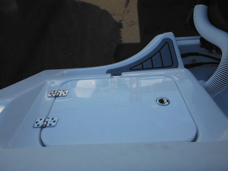 Slide: The Image of 2025 Tidewater 232 LXF boat deck with storage compartment and hose. - 40