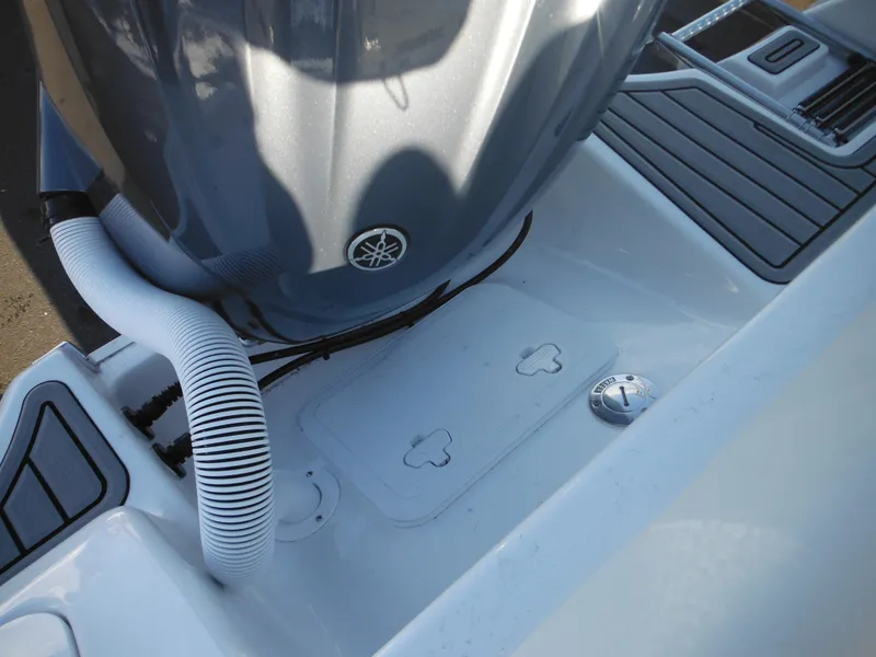 Slide: The Image of 2025 Tidewater 232 LXF boat engine compartment with Yamaha motor and sleek design. - 42