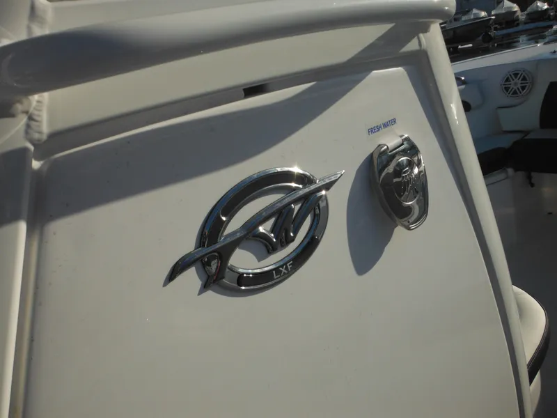 Slide: The Image of 2025 Tidewater 232 LXF boat emblem and freshwater access detail. - 45
