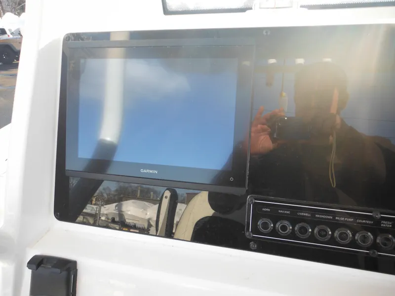 Slide: The Image of 2025 Tidewater 232 LXF boat dashboard with Garmin display and control panel. - 49