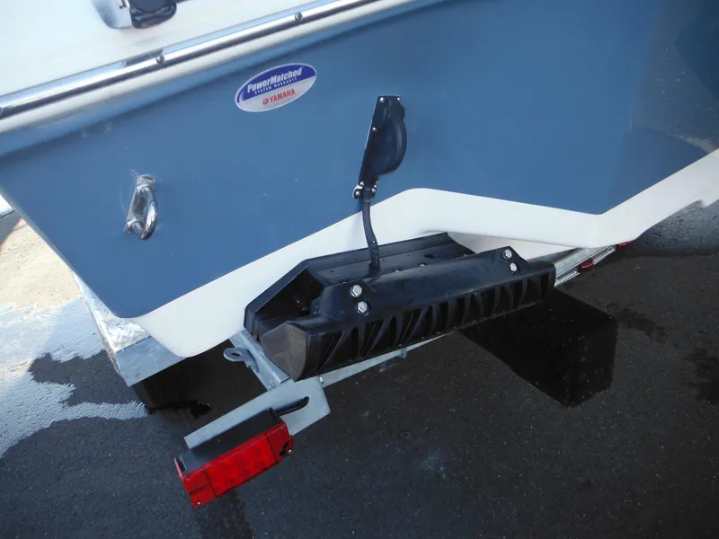 Slide: The Image of 2025 Tidewater 232 LXF boat trailer detail with blue hull and red reflector. - 5