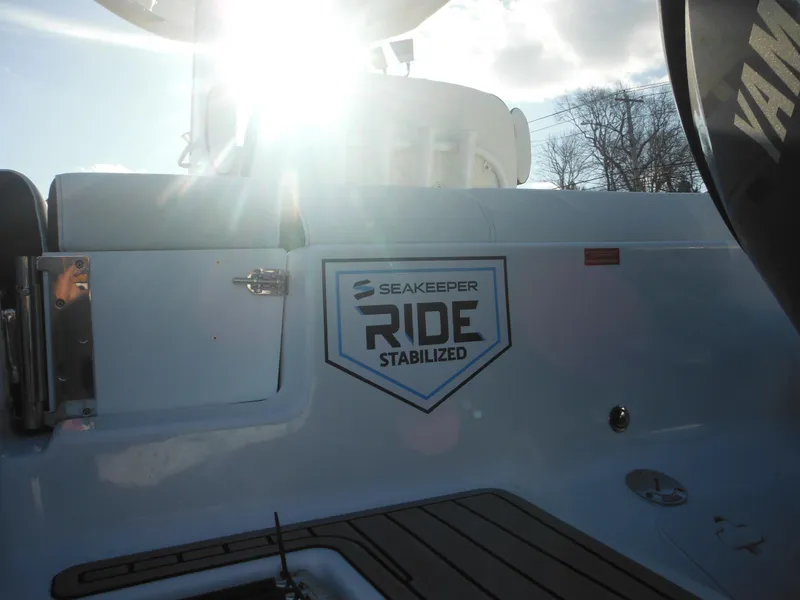 Slide: The Image of 2025 Tidewater 232 LXF boat with Seakeeper Ride stabilization, sunlit deck view. - 6