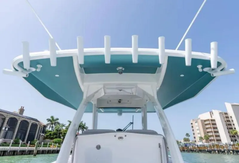 Slide: The Image of 2023 Intrepid 375 boat with sleek design, viewed from below, docked near waterfront buildings. - 11