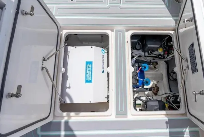 Slide: The Image of 2023 Intrepid 375 boat engine compartment with open hatches, showcasing mechanical components. - 12