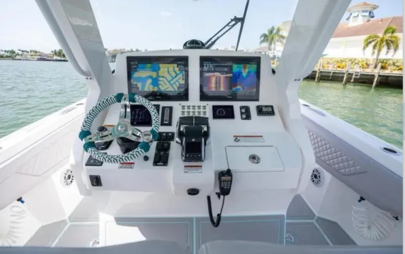 Slide: The Image of 2023 Intrepid 375 boat dashboard with advanced navigation and control systems. - 14