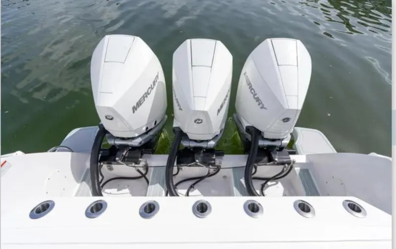 Slide: The Image of Triple Mercury outboard engines on a 2023 Intrepid 375 boat, docked on water. - 15