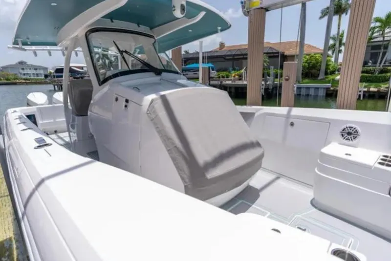 Slide: The Image of 2023 Intrepid 375 boat docked, featuring sleek design and spacious deck. - 18