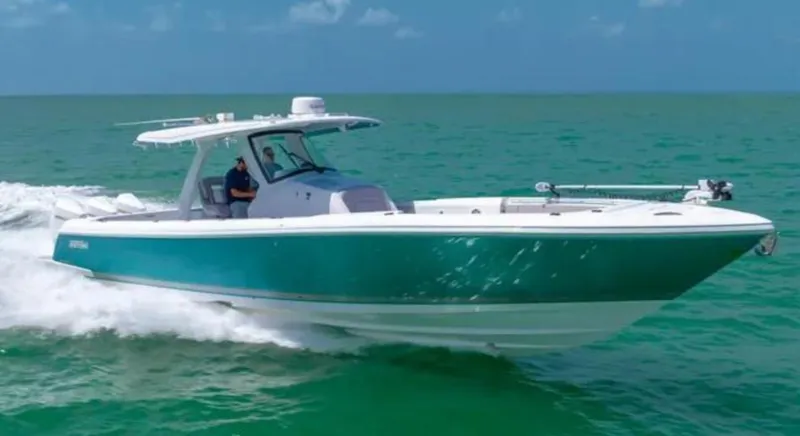 Slide: The Image of 2023 Intrepid 375 boat cruising on turquoise ocean waters. - 2