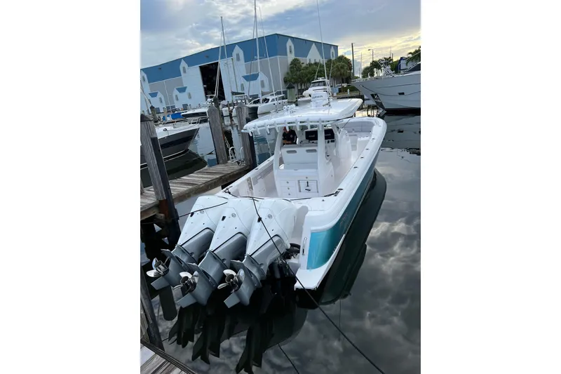 Slide: The Image of 2023 Intrepid 375 boat docked with triple outboard engines. - 20