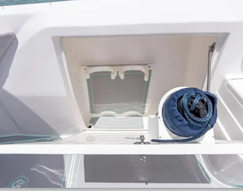 Slide: The Image of 2023 Intrepid 375 boat storage compartment with coiled rope and hatch. - 6