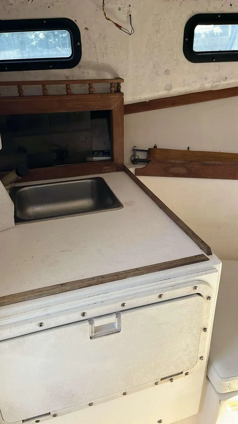 Slide: The Image of 1987 Nauset 249 boat interior with sink and storage area. - 10