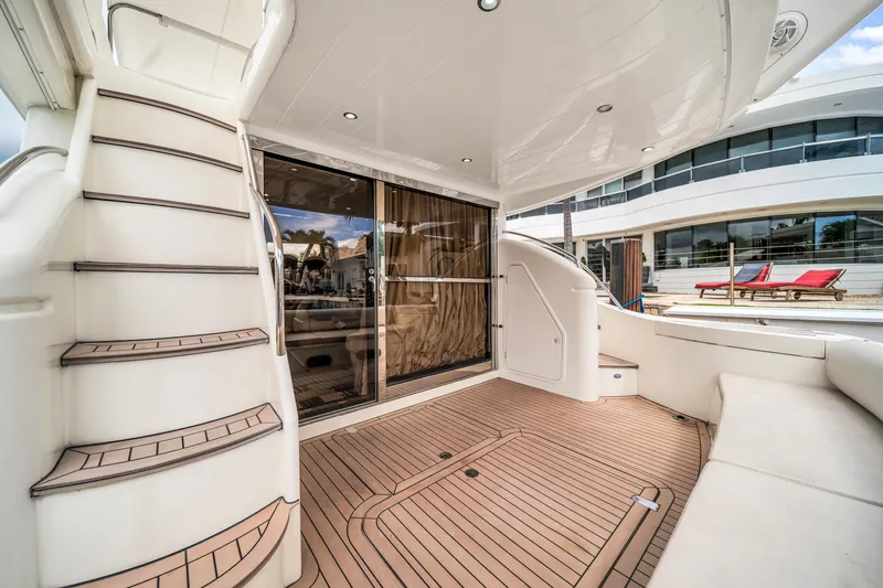 Slide: The Image of Luxurious 2002 Princess 61 yacht deck with elegant wood flooring and sleek staircase. - 14