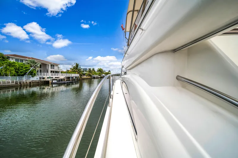 Slide: The Image of Side view of a 2002 Princess 61 yacht on a scenic waterway. - 17