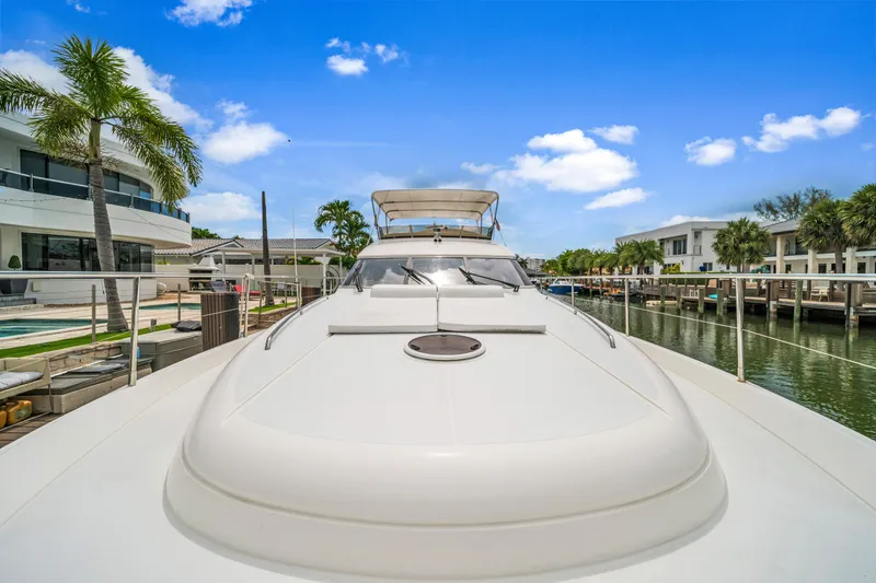 Slide: The Image of Luxury Princess 61 yacht docked in a sunny marina, 2002 model. - 19