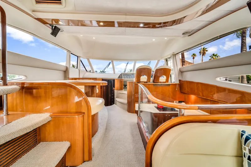 Slide: The Image of Luxurious interior of a 2002 Princess 61 yacht with elegant wood finishes and spacious seating. - 21