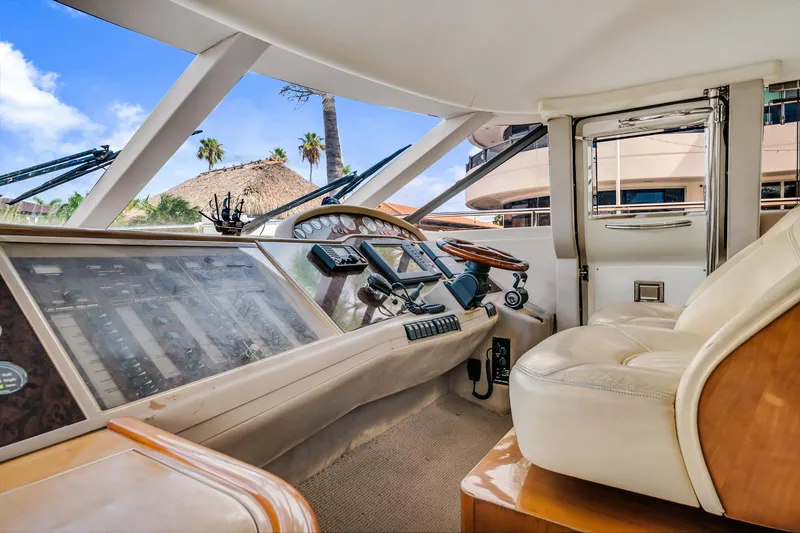 Slide: The Image of Interior view of a 2002 Princess 61 yacht cockpit with luxurious seating and control panel. - 22