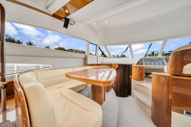 Slide: The Image of Luxurious interior of a 2002 Princess 61 yacht with elegant seating and panoramic windows. - 23