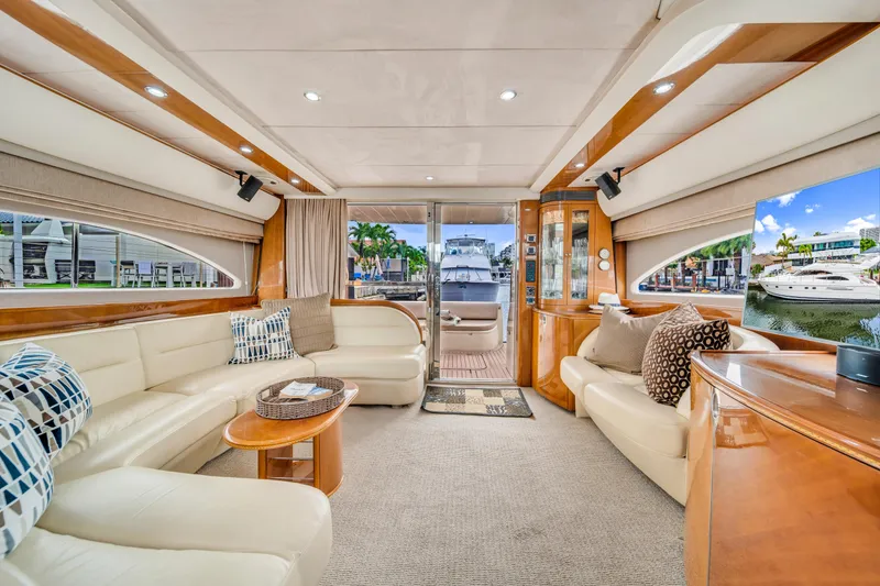 Slide: The Image of Luxurious interior of a 2002 Princess 61 yacht with elegant seating and wood accents. - 25