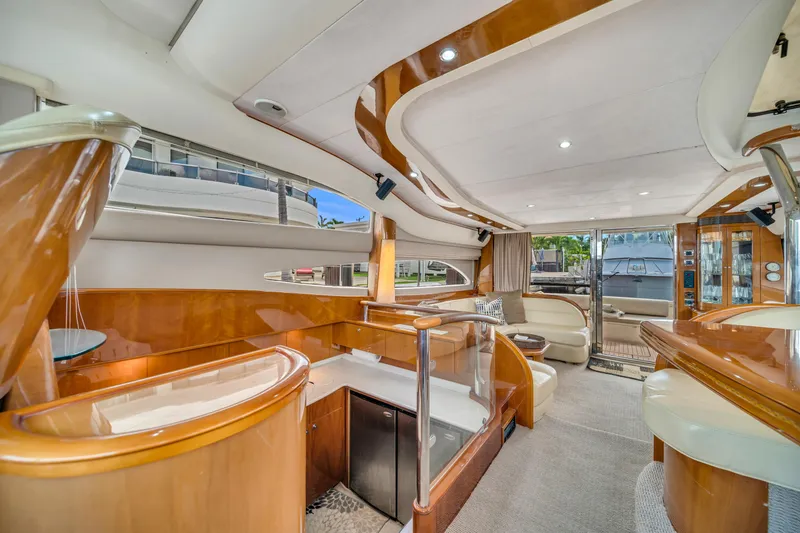 Slide: The Image of Luxurious interior of a 2002 Princess 61 yacht with elegant wood finishes and modern design. - 28