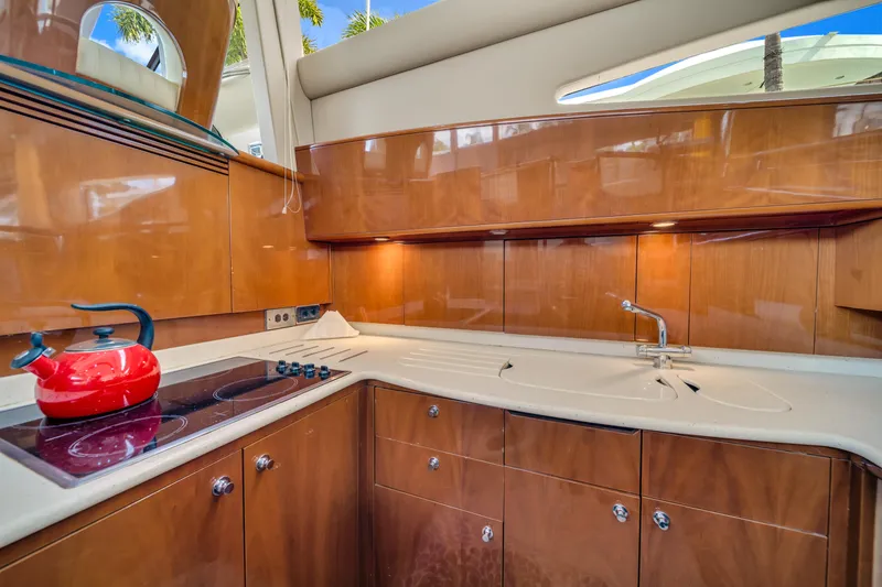 Slide: The Image of Luxurious kitchen interior of 2002 Princess 61 yacht with wooden cabinetry and modern appliances. - 29