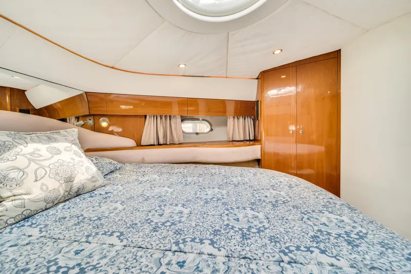 Slide: The Image of Luxurious cabin interior of 2002 Princess 61 yacht with elegant bedding and wood paneling. - 35