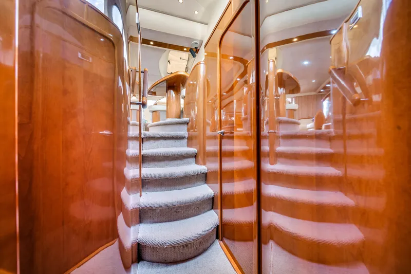 Slide: The Image of Luxurious interior of 2002 Princess 61 yacht with polished wood and carpeted stairs. - 37