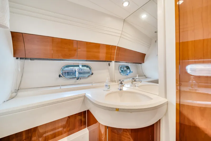 Slide: The Image of Luxurious bathroom interior of 2002 Princess 61 yacht with sleek wood accents. - 38