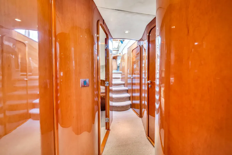 Slide: The Image of Luxurious interior hallway of a 2002 Princess 61 yacht with polished wood finishes. - 43