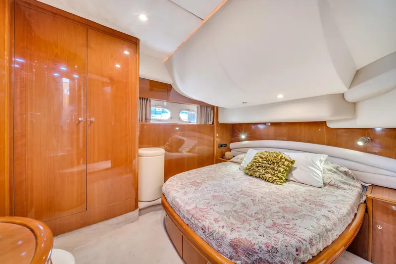 Slide: The Image of Luxurious bedroom interior of 2002 Princess 61 yacht with elegant wood finishes. - 47