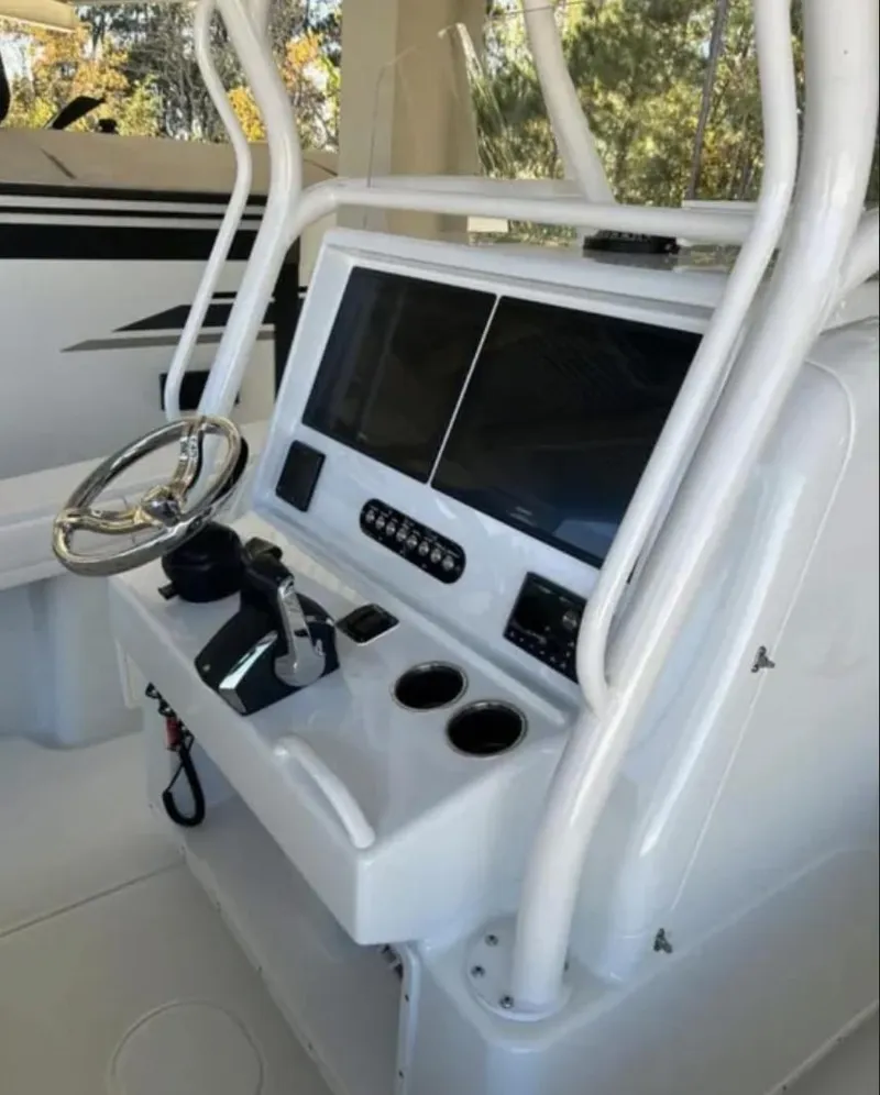 Slide: The Image of 2024 Yellowfin 36 Offshore boat console with steering wheel and controls. - 3