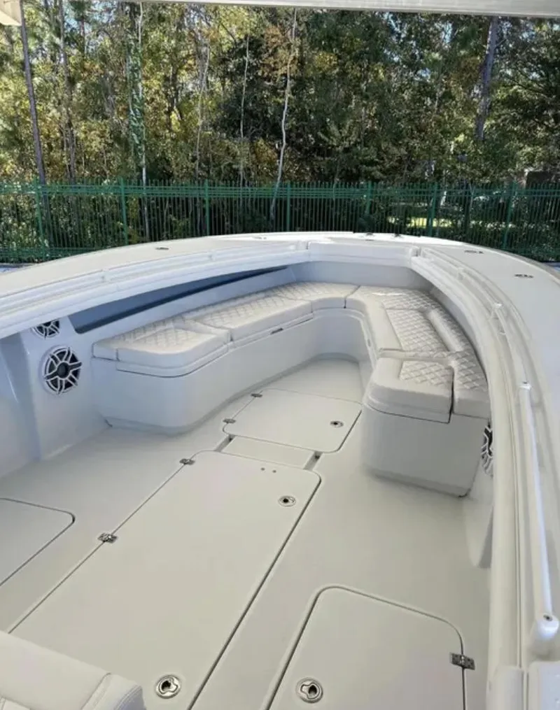 Slide: The Image of 2024 Yellowfin 36 Offshore boat interior with cushioned seating and spacious deck. - 6