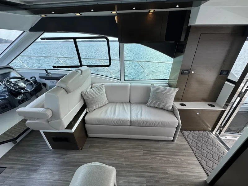 Slide: The Image of Interior of 2017 Cruisers Yachts 45 Cantius with modern seating and panoramic windows. - 11
