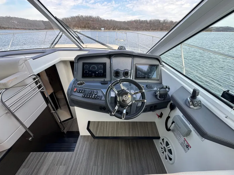 Slide: The Image of Helm of 2017 Cruisers Yachts 45 Cantius with modern navigation equipment on a serene lake. - 13