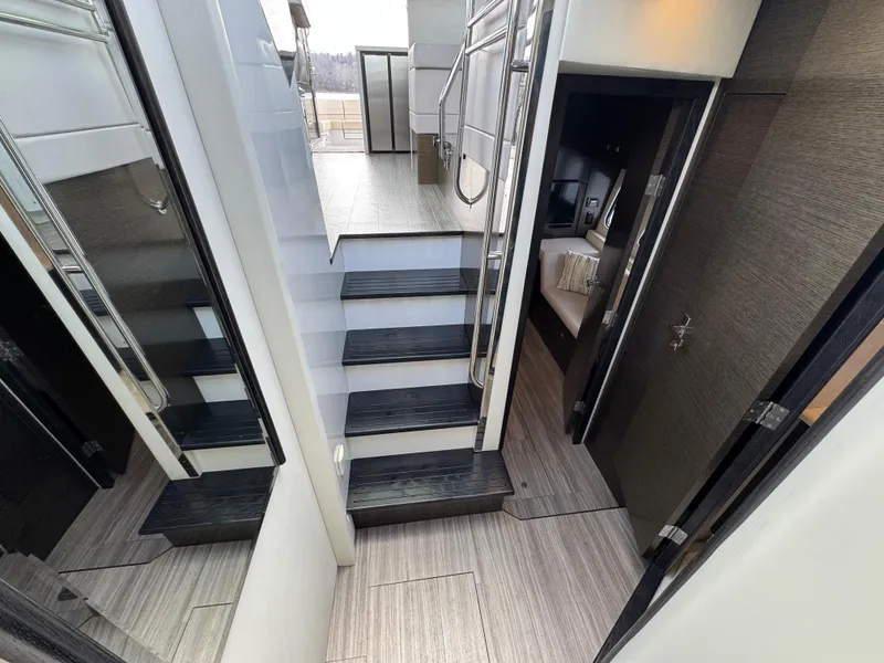 Slide: The Image of Interior of 2017 Cruisers Yachts 45 Cantius, featuring modern stairs and sleek design. - 19