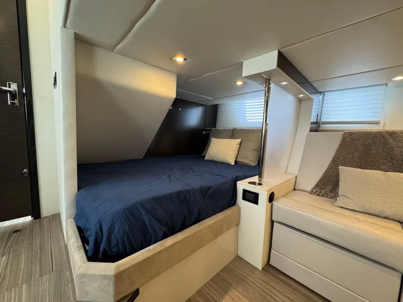 Slide: The Image of 2017 Cruisers Yachts 45 Cantius interior cabin with bed and seating area. - 22