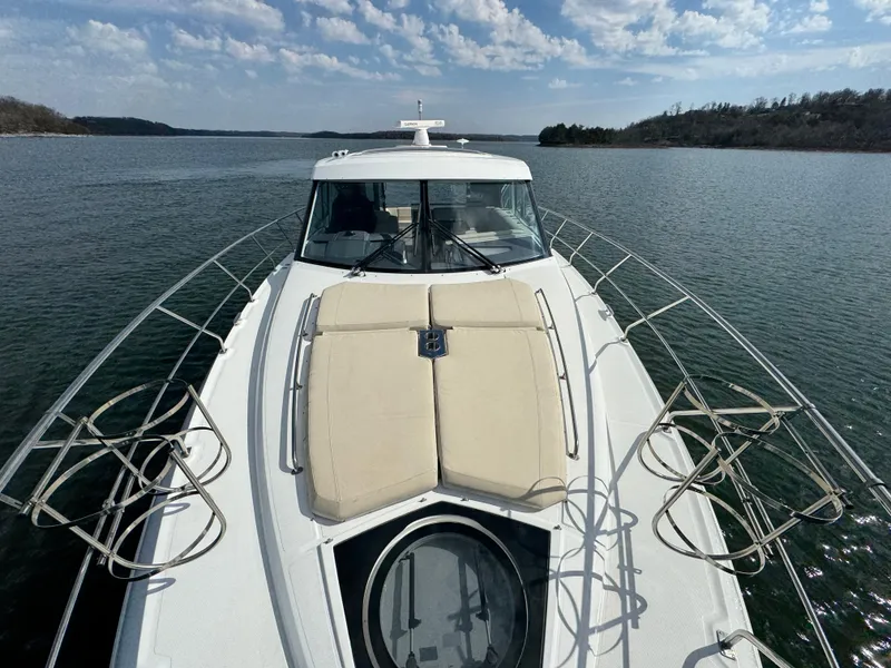 Slide: The Image of 2017 Cruisers Yachts 45 Cantius on serene water under a partly cloudy sky. - 3