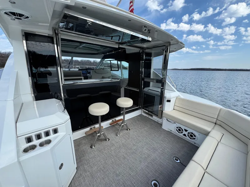 Slide: The Image of 2017 Cruisers Yachts 45 Cantius cockpit with seating, stools, and water view. - 7