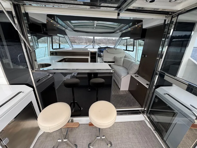 Slide: The Image of 2017 Cruisers Yachts 45 Cantius interior with modern seating and panoramic windows. - 8