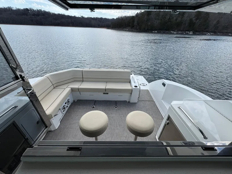 Slide: The Image of 2017 Cruisers Yachts 45 Cantius interior with lake view, featuring seating and stools. - 9