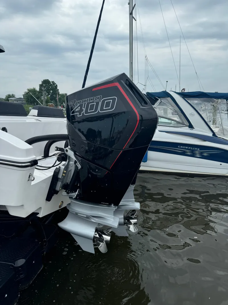 Slide: The Image of 2025 Fountain 38SCX boat with powerful outboard motor in marina setting. - 13