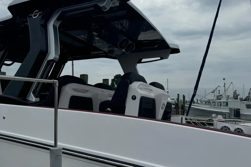 Slide: The Image of 2025 Fountain 38SCX boat with sleek design docked at marina. - 14