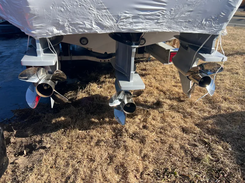 Slide: The Image of 2025 Fountain 38 SCX boat propellers on dry grass. - 15