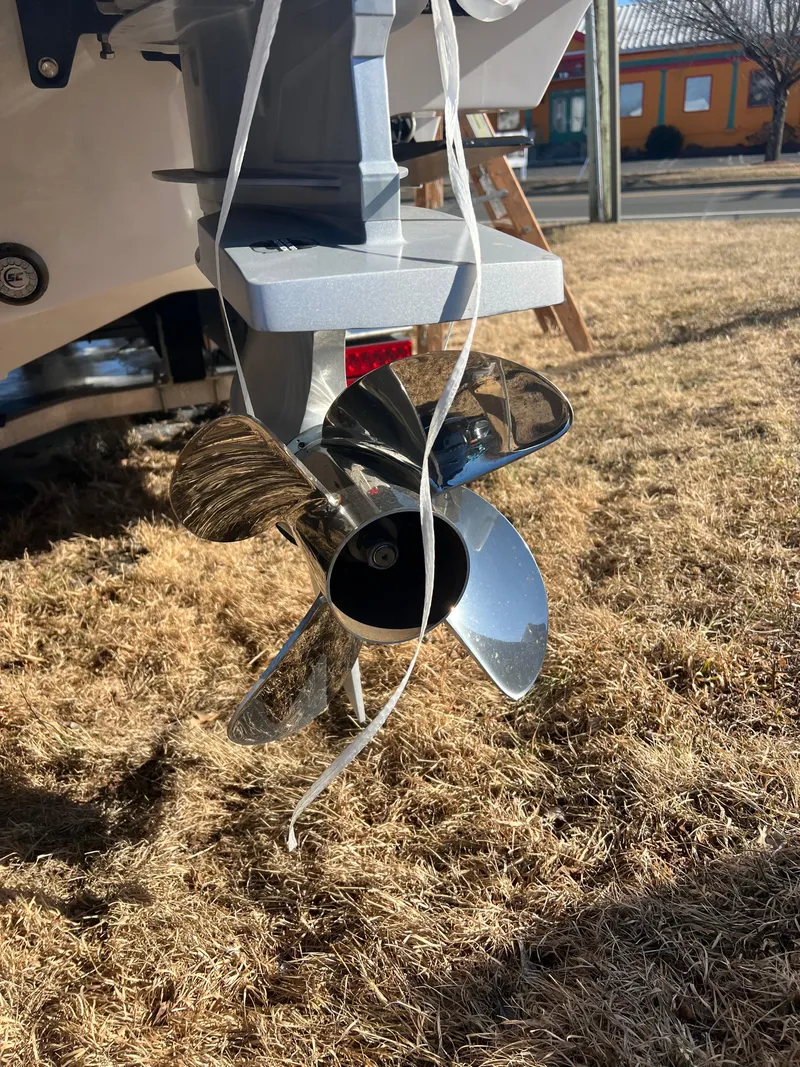 Slide: The Image of Close-up of a 2025 Fountain 38 SCX boat propeller on dry grass. - 18