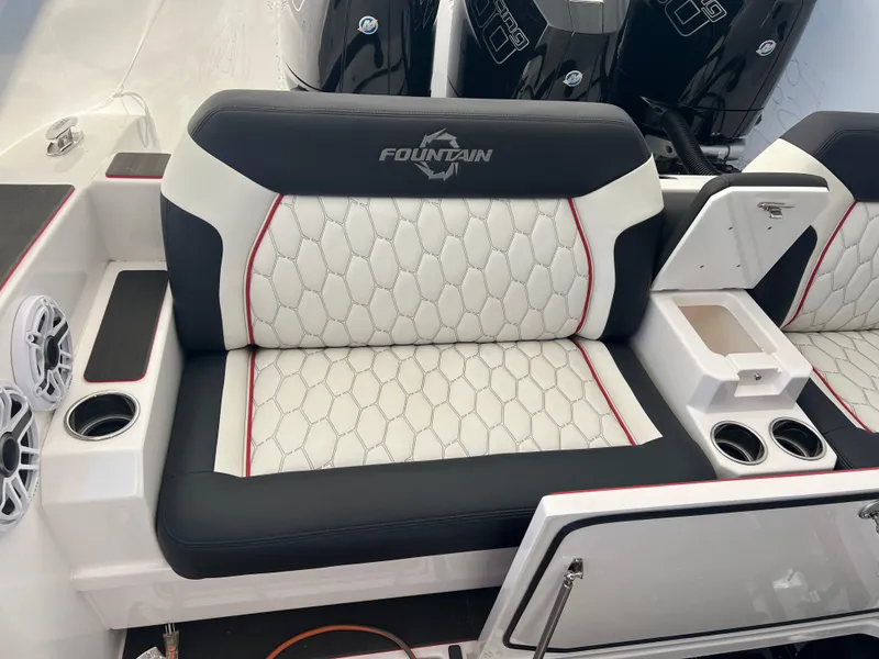 Slide: The Image of 2025 Fountain 38 SCX boat seat with black and white upholstery, cup holders, and speakers. - 19