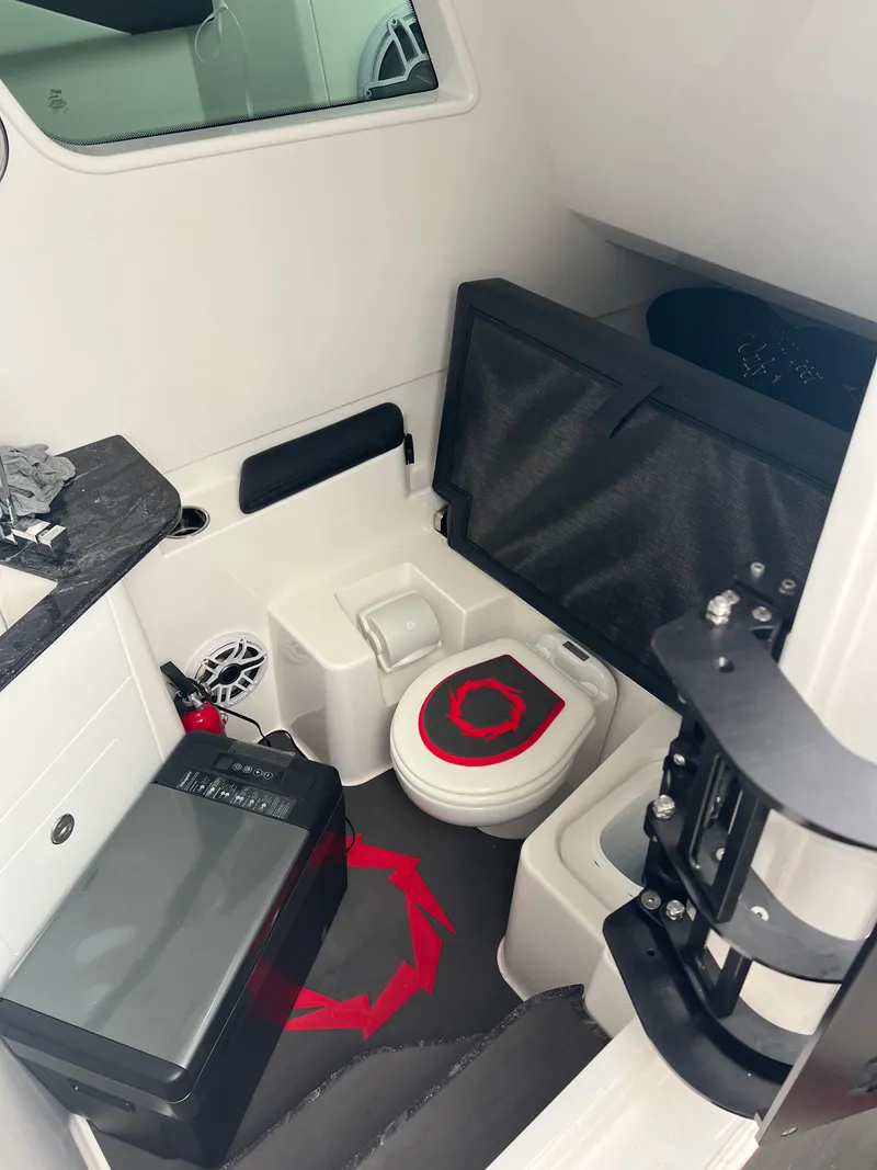 Slide: The Image of 2025 Fountain 38 SCX boat interior with compact bathroom and modern amenities. - 23